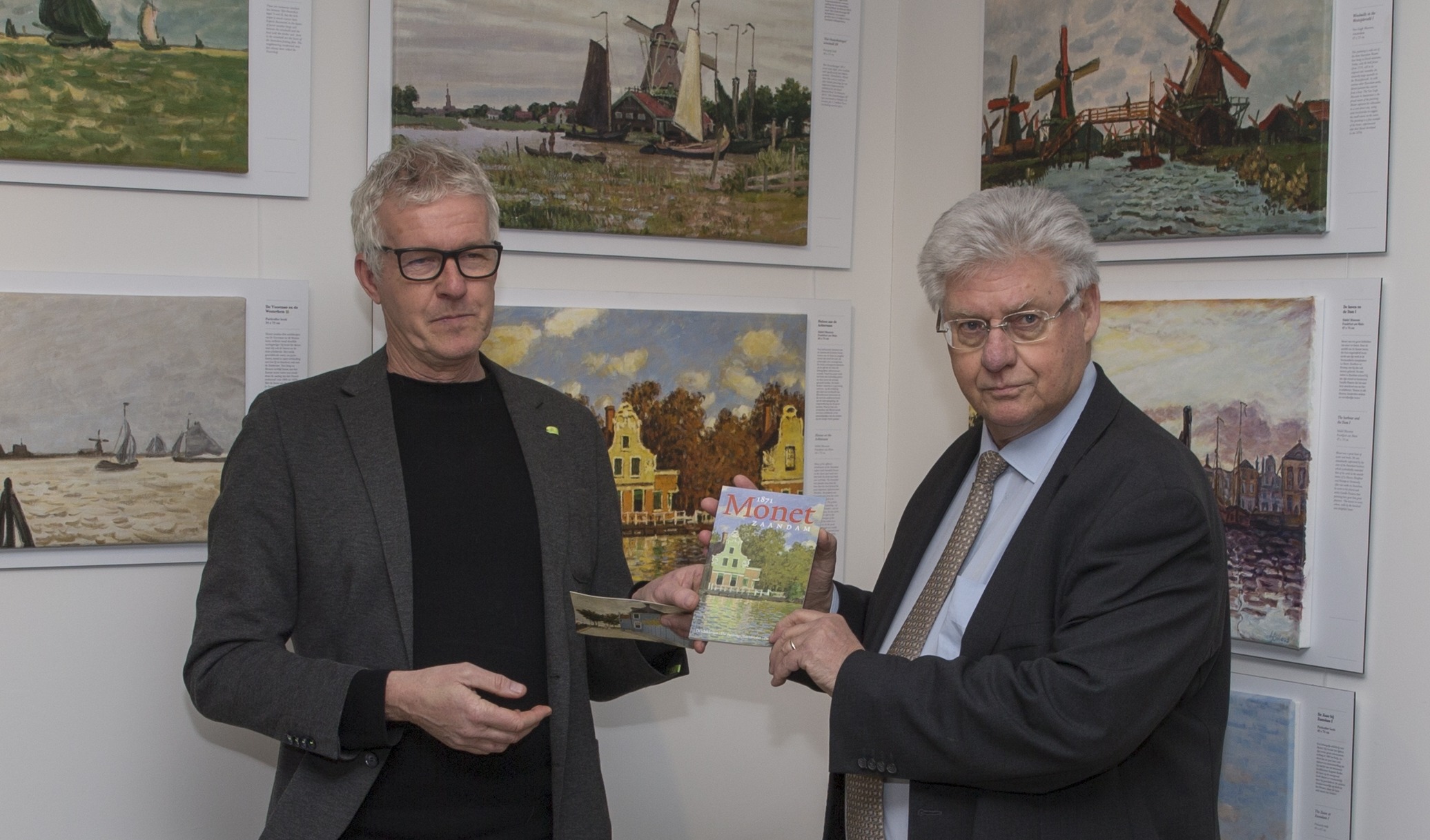 Waarnemend burgemeester van Zaanstad Ruud Vreeman ontvant het eerste exemplaar van Gert Schouten, voorzitter van de Stichting Monet in Zaandam